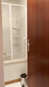 a door to a bathroom with a shower and a toilet at Apartment Kaltenbrunn Serviced Apt mit Seeblick am Tegernsee Business & Long Stay only in Gmund am Tegernsee