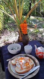 a blue table with a plate of food on it at Sala Thongyon - Guest House in Savannakhet