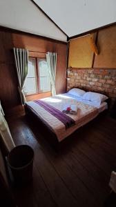 a bedroom with a large bed in a room at Sala Thongyon - Guest House in Savannakhet