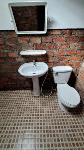 a bathroom with a sink and a toilet at Sala Thongyon - Guest House in Savannakhet