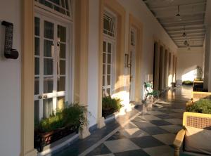 a porch of a house with a checkered floor at The Harrington Residency in Kolkata