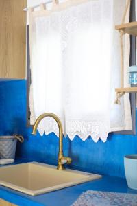 a kitchen counter with a sink and a window at Lavender farm house in Nafpaktos