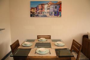 マルベーリャにあるCasa en Marbellaのダイニングテーブル(椅子付)が備わります。壁には絵画が飾られています。