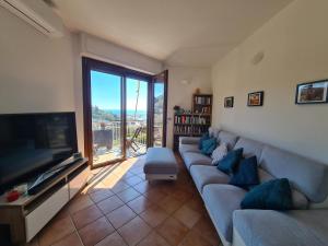 a living room with a couch and a flat screen tv at Casa Erica by PortofinoVacanze in Rapallo