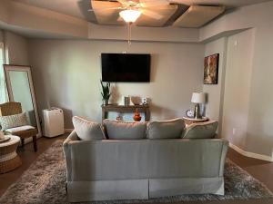 a living room with a couch and a flat screen tv at E Atlanta 10mins to downtown 15 mins to airport Spacious Apartment in Atlanta