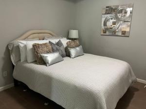 a bed with pillows on it in a bedroom at E Atlanta 10mins to downtown 15 mins to airport Spacious Apartment in Atlanta
