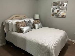 a bed with pillows on it in a bedroom at E Atlanta 10mins to downtown 15 mins to airport Spacious Apartment in Atlanta