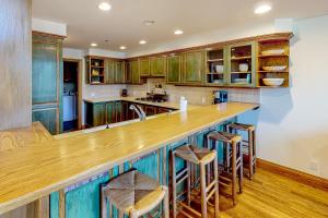 a kitchen with wooden cabinets and a counter with stools at Baldy View Lodge in Ketchum