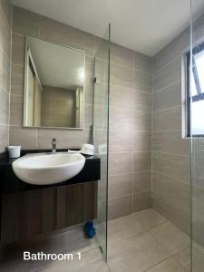 a bathroom with a sink and a glass shower at Homestay Damansara 2BD 2Parking in Petaling Jaya