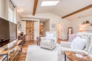 a living room with white furniture and a table at Drift Creek Casa in Lincoln City