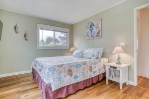 a bedroom with a bed and a window at Lincoln House in Lincoln City