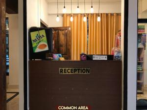 a reception area with a television and a popcorn machine at Gracious Lodge in Shillong