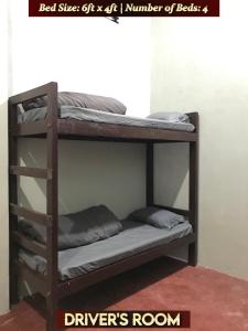 a wooden bunk bed with a number of beds at Gracious Lodge in Shillong