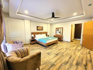 1 dormitorio con 1 cama y 2 sillas en Executive Apartments In Bahria Heights en Rawalpindi