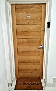 a wooden door with the number four on it at Charlotte Double Room in London