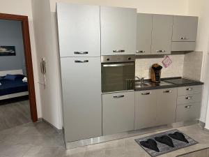 a kitchen with white cabinets and a stove top oven at Saint Peter Vatican City confortable Apartament Stellasia casa vacanza in Rome