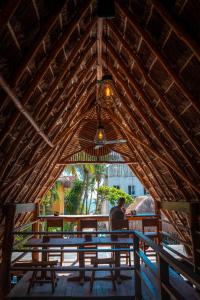 a man sitting at a table in a straw hut at Tunich Jungle Cabañas in Tulum