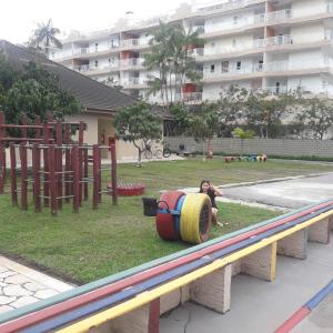 a person laying on a seesaw at a playground at APARTAMENTO EM BERTIOGA in Bertioga