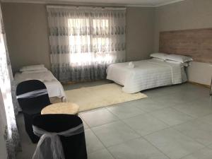 Ένα ή περισσότερα κρεβάτια σε δωμάτιο στο Ericgret Guesthouse