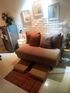 a couch sitting in a living room at Tiny studio with pool, jogging track, gym and Mall in Jakarta