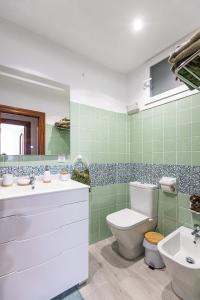 een groene badkamer met een toilet en een wastafel bij ¡Recién publicado!Amezola - Bilbao in Bilbao