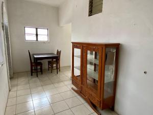a dining room with a cabinet and a table at HOTEL MAYA IXTLAN in Ixtlán del Río
