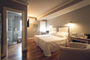 Posteľ alebo postele v izbe v ubytovaní Hostal Los Castañuelos