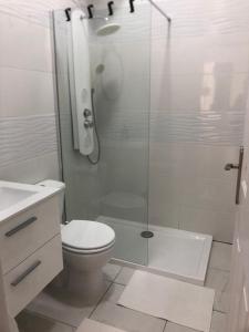 a white bathroom with a shower and a toilet at Chayofa Hills - 2 Bedroom Apartment with Ocean Views and Air-condition A in Chayofa