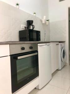 a kitchen with a microwave on top of a stove at Chayofa Hills - 2 Bedroom Apartment with Ocean Views and Air-condition A in Chayofa