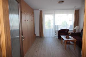a living room with a couch and a table at Haus Norderhoog Wohnung 39 in Westerland
