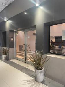 a room with two potted plants in a building at Bristol Condominio Apart Hotel in Mar del Plata