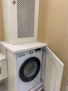 a washer and dryer sitting in a room at Classic and New brand Apartment San Stefano 9 in Varna City