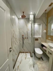 a bathroom with a shower and a toilet and a sink at Classic and New brand Apartment San Stefano 9 in Varna City