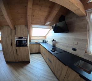 a small kitchen with a black counter top in a room at Casa Betty in Bormio