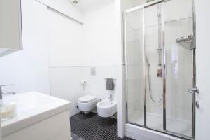 biała łazienka z prysznicem i toaletą w obiekcie Easylife - Annydi Art Home in Duomo w Mediolanie
