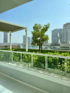 einen Balkon mit Blick auf einen Baum in der Unterkunft Wonderful Reva Aparthotel Downtown in Dubai