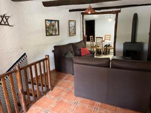 a living room with a couch and a fireplace at Casa Pepo in Pampaneira