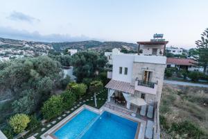 an aerial view of a house with a swimming pool at Villa Emmanouela in Pitsidia