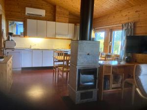 a kitchen with a wood stove in a room at Stuga Huså Åre in Huså