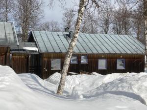 HusåにあるStuga Huså Åreの雪の木造小屋