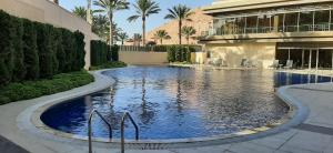 a swimming pool in the middle of a building at Al Raha Village Aqaba in Aqaba