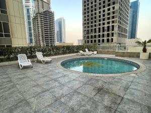 a swimming pool on the roof of a building at Sea View 1BR apartment - Marina Pinnacle in Dubai