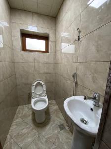 a bathroom with a toilet and a sink at Qusar House in Qusar