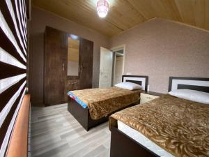 a hotel room with two beds and a mirror at Qusar House in Qusar