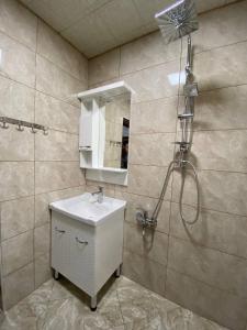 a bathroom with a sink and a shower at Qusar House in Qusar