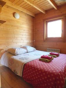 ein Schlafzimmer mit einem Bett in einem Holzzimmer in der Unterkunft Camping, Hôtel De Plein Air Les Cariamas in Chateauroux-les-Alpes
