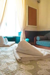 a bedroom with a bed with towels on it at Olimpo degli Dei in Naples