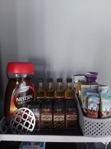 a refrigerator shelf with jars of peanut butter and other food items at Lough View Lodge in Dunnamanagh