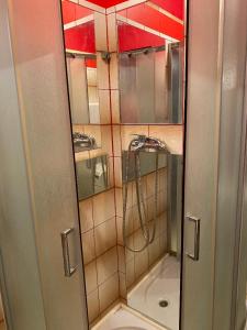 a shower with a glass door in a bathroom at Adorable 1-bedroom guesthouse & private parking place in Velika Mlaka