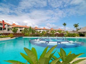 a large swimming pool in front of a resort at Garden Suites by Meliá - All inclusive in Punta Cana